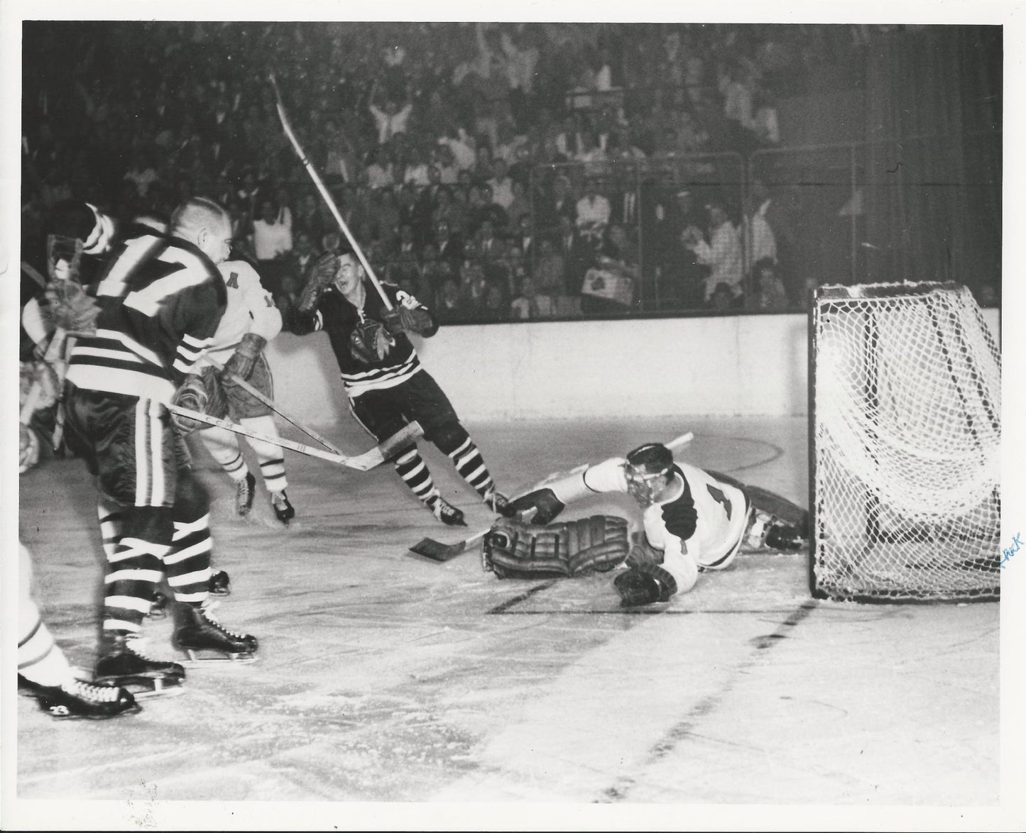 Stan Mikita celebrates a score on Jacques Plante original 1960 photo